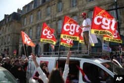 FILE - CGT union members demonstrate against French President Emmanuel Macron's push to raise France's retirement age from 62 to 64, at a march in Bordeaux, southwestern France, March 28, 2023.