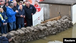 German Chancellor Olaf Scholz speaks to Bavaria State Prime Minister Markus Soeder as they visit Reichertshofen, in the aftermath of severe flooding, near Ingolstadt, Germany, June 3, 2024.