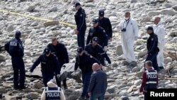 Police work at the scene of a car crash where several people, including migrants, were killed, near Kelcyre, Albania, Apr. 2, 2024. 