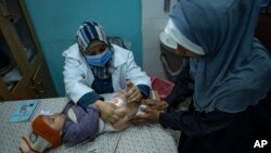 FILE - A Palestinian child receives a vaccine in Rafah, Gaza Strip, Jan. 2, 2024.
