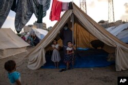 Palestinian children displaced by the Israeli bombardment of the Gaza Strip stay in a UNDP-provided tent camp in Khan Younis on Oct. 19, 2023.