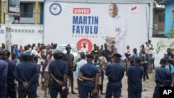 Security forces stand guard as they gather to prevent protests by supporters of presidential candidate Martin Fayulu outside his opposition party's headquarters in Kinshasa, Democratic Republic of the Congo, Dec. 27, 2023.