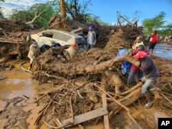 People try to clear debris after devastating flooding in Kamuchiri village, Mai Mahiu, Nakuru County, Kenya, April 29, 2024.