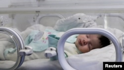 A baby girl born during a deadly earthquake earlier this month lies in the Jihan Hospital in Afrin, Syria, Feb. 18, 2023. 