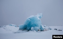 Blue ice is seen at frozen Kongsfjord near Ny-Aalesund, Svalbard, April 8, 2023.