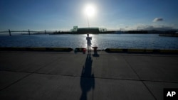An angler fishes at Onahama Port in Iwaki, northeastern Japan, 68 kilometers from the Fukushima Daiichi nuclear power plant, damaged by a massive March 11, 2011, earthquake and tsunami, on Aug. 25, 2023. 