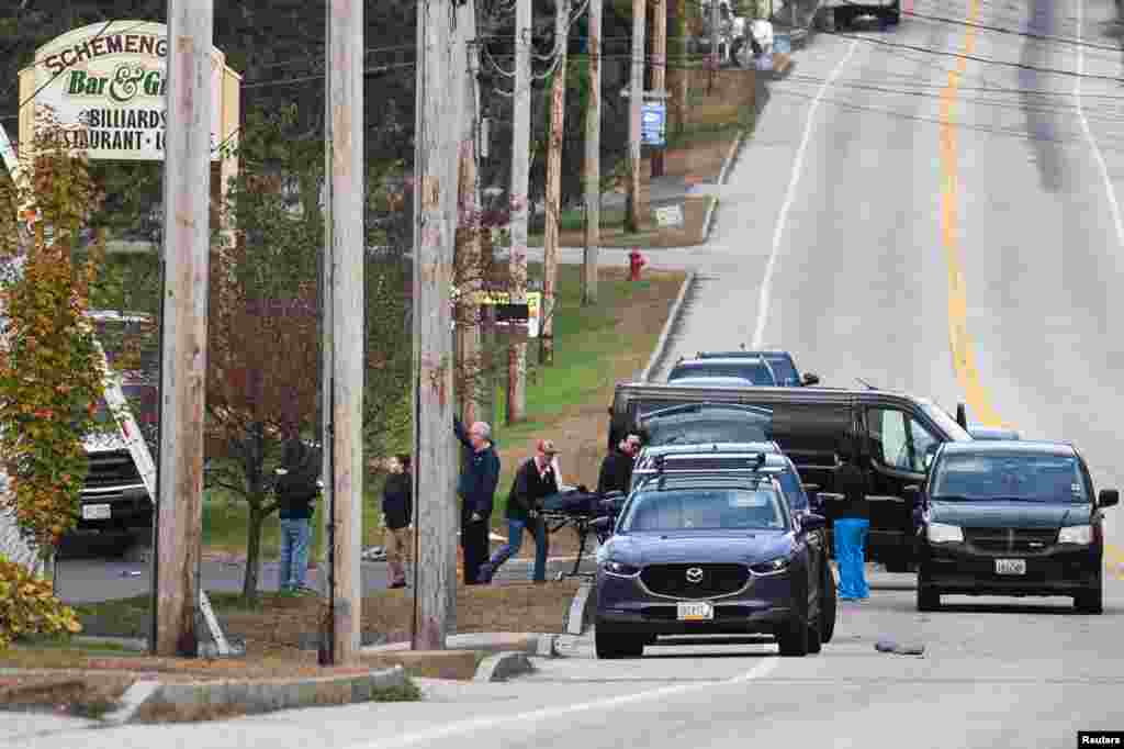 Police remove a victim from the Schemengees Bar &amp; Grille Restaurant after deadly mass shootings in Lewiston, Maine.