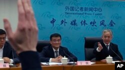 FILE - Deputy director of China's Eurasia Department Yu Jun, center, looks on as the Foreign Ministry's spokesman Wang Wenbin gestures during a briefing following Chinese President Xi Jinping's phone call with Ukrainian President Volodymyr Zelenskyy, in Beijing, April 26, 2023.