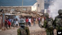 Protesters shout at police as they demonstrate in the Kibera slum of Nairobi, Kenya, March 20, 2023.