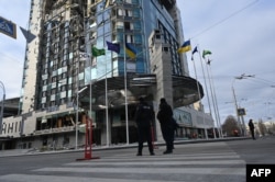 Policemen stand outside the Kharkiv Palace hotel, which was damaged the night before by a Russian missile attack, in Kharkiv, on Dec. 31, 2023, amid the Russian invasion of Ukraine.