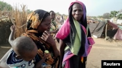 Sudanese refugees who fled the violence in their country gather near the border between Sudan and Chad, in Koufroun, Chad April 29, 2023.