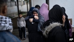 Palestinians mourn their relatives killed in the Israeli bombardment of the Gaza Strip, at a hospital in Rafah, southern Gaza, Dec. 14, 2023.