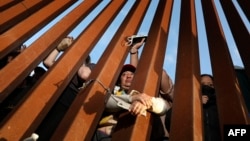 Migrants wait for asylum hearings at the US-Mexico border on May 11, 2023, as seen from San Ysidro, California. COVID rules that have prevented hundreds of thousands from claiming asylum expired, creating uncertainty for migrants.