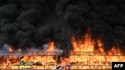 A burning pile of seized illegal drugs is seen during a destruction ceremony to mark the 'International Day against Drug Abuse and Illicit Trafficking' in Yangon on June 26, 2023. 