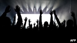 People attend a concert of the Bi-2 rock band at the Arena COS Torwar in Warsaw, Poland, March 16, 2024.