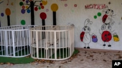 FILE - Empty playpens are seen in the courtyard of Kherson regional children's home, in Kherson, southern Ukraine, Nov. 25, 2022.