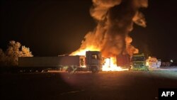 This handout photograph taken on Sept. 13, 2023, by the press center of the Defense Forces of Southern Ukraine shows burning trucks following Russian drone attacks in Odesa region