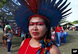 Tawrepang Indigenous woman Leticia Monteiro da Silva poses for photos at the Caracarana Lake Regional Center in Normandia, on the Raposa Serra do Sol Indigenous reserve in Roraima state, Brazil, Monday, March 13, 2023. (AP Photo/Edmar Barros)