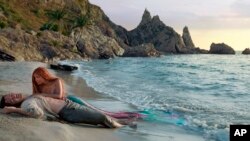 This image released by Disney shows Jonah Hauer-King as Prince Eric, left, and Halle Bailey as Ariel in "The Little Mermaid."