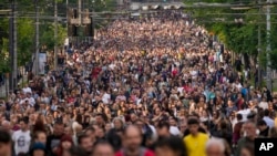 People march during a protest against violence in Belgrade, Serbia, May 19, 2023. Rallies this month were sparked by two mass shootings in the Balkan country, even as officials rejected the criticism and ignored their demands.