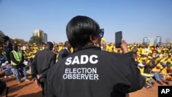 An election observer takes pictures at an opposition campaign rally in Harare, Zimbabwe, on Aug. 21, 2023.