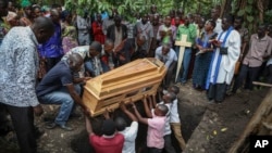 Relatives mourn as the coffin of Florence Masika, who was killed along with her son Zakayo Masereka by suspected rebels as they retreated from Saturday's attack on the Lhubiriha Secondary School, is buried in Nyabugando, Uganda, June 18, 2023. 