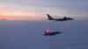 FILE - In this March 9, 2020, photo released by the North American Aerospace Defense Command (NORAD), a Russian Tu-142 maritime reconnaissance aircraft, top, is intercepted near Alaska. NORAD said it tracked two Russian and two Chinese aircraft off the coast of Alaska.