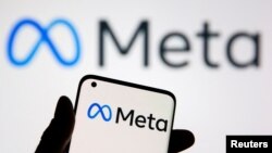 FILE - A smartphone with Meta logo is seen in front of displayed Facebook's new rebrand logo Meta in this illustration taken Oct. 28, 2021. 