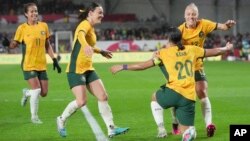FILE - Australia's Sam Kerr, second right, celebrates with teammates after scoring against England during their women's international friendly soccer match in London, April 11, 2023.