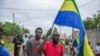 People celebrate in support of the coup leaders in a street of Port-Gentil, Gabon Aug. 30, 2023.