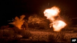 A Ukrainian soldier fires during night training in Ukraine's partially Russian-occupied Donetsk region, Aug. 17, 2023.