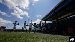 FILE - Players from Team Texas run to dugout during the DYB Little League tournament in Ruston, La., Aug. 9, 2023. With temperatures higher, players and spectators have to pay attention to the heat.