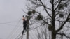 A worker repairs a power line following a Russian strike in the village of Velyka Vilshanytsia, some 50km from Lviv, on March 9, 2023.