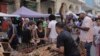 Shoppers gather around a cart of garlic at a street market in Havana, Cuba, March 16, 2024. 