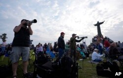 People gather to watch SpaceX's mega rocket Starship launch it's third test flight from Starbase in Boca Chica, Texas, Thursday, March 14, 2024. (AP Photo/Eric Gay)