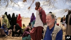 FILE - World Food Program chief David Beasley meets with villagers in the village of Wagalla in northern Kenya, Aug. 19, 2022.