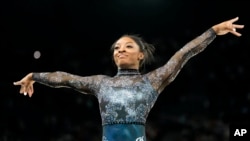 Simone Biles, of United States, competes on the floor exercise during a women's artistic gymnastics qualification round at Bercy Arena at the 2024 Summer Olympics, Sunday, July 28, 2024, in Paris.