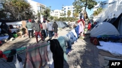 Sub-Saharan African migrants camp outside the headquarters of the International Organization for Migration in Tunis, Tunisia, March 2, 2023.
