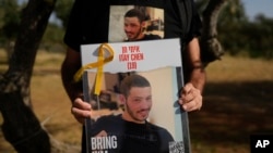 Ruby Chen holds a poster of his son, Itay Chen, during a protest near Israel's parliament in Jerusalem, March 9, 2024.