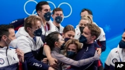 FILE - Madison Chock and Evan Bates, of the United States, reacts after the team ice dance program during the figure skating competition at the 2022 Winter Olympics, Feb. 7, 2022, in Beijing.