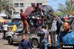 Palestinians flee Rafah after Israeli forces launched a ground and air operation in the eastern part of the southern Gaza city, in Rafah, May 8, 2024.
