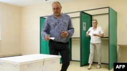 A voter casts a ballot during the second round of the country's presidential election at a polling station in Vilnius, Lithuania on May 26, 2024. 