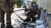 South Korean soldiers wearing protective gear check the trash from a balloon presumably sent by North Korea, in Incheon, South Korea, June 2, 2024. 