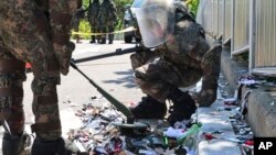 South Korean soldiers wearing protective gear check the trash from a balloon presumably sent by North Korea, in Incheon, South Korea, June 2, 2024. 