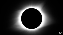 FILE - The moon covers the sun during a total solar eclipse, Aug. 21, 2017, in Cerulean, Kentucky.
