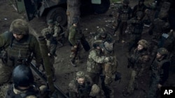 Ukrainian soldiers hug as they go to rest at the frontline near Bakhmut in the Donetsk region, Ukraine, May 27, 2023.