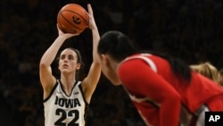 Iowa guard Caitlin Clark (22) takes a free throw against Ohio State during the second half of an NCAA college basketball game, in Iowa City, Iowa, March 3, 2024. 