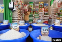 Seorang pedagang menata sekarung beras di pasar tradisional Bekasi, 1 Maret 2024. (Foto: REUTERS/Ajeng Dinar Ulfiana)