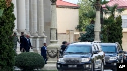 Representatives of the Armenian community of Nagorno-Karabakh leave the building after the talks in the Azerbaijani city of Yevlakh, Azerbaijan, Sept. 21, 2023. 