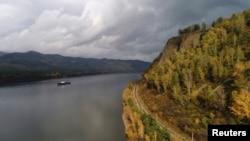 FILE - A vessel transports supplies along the Yenisei River from St. Petersburg through the Arctic Ocean to a hydroelectric power station outside Krasnoyarsk, Siberia, Russia, Sept. 19, 2017. Many experts are watching China’s arctic activities, with a likely focus on Russia.